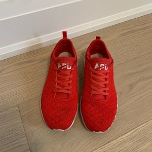 Red APL running shoes